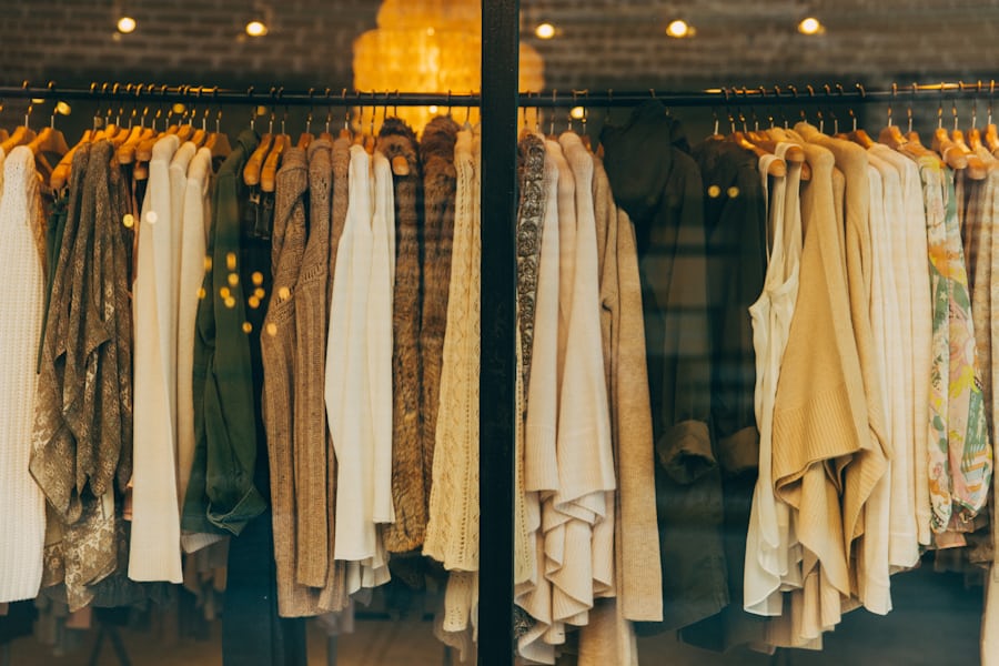 Elegant timeless clothing collection on a boutique rack, the essence of Caroll's French wardrobe